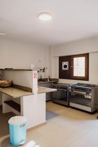 a large kitchen with stainless steel appliances and a window at The Wind Farm in Dahab