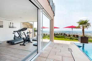 a home gym with a view of the ocean at Burghotel Staufeneck in Salach