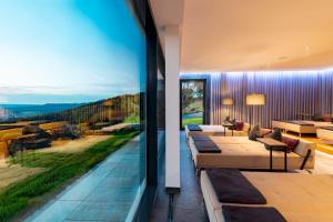 a living room with a large glass window at Burghotel Staufeneck in Salach