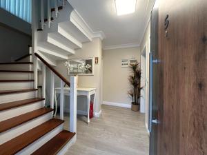 a hallway with stairs and a table in a house at Riyan Garden Villas in Sapanca