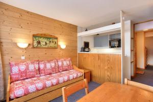 uma sala de estar com um sofá e uma mesa em Quartier Crève Cœur - maeva Home - Appartement 2 pièces 5 personnes - Con 244 em Valmorel