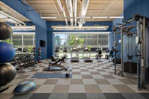 a gym with cardio equipment and a checkered floor at Aloft Minneapolis in Minneapolis