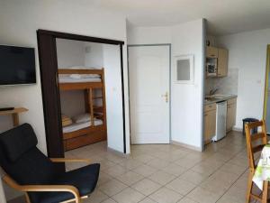 a living room with a mirror and a room with a kitchen at Résidence Gardette - Studio pour 4 Personnes 504 in Réallon