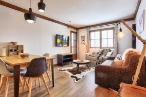 a living room with a couch and a table at Résidence Les Arcs Le Village - maeva Home - Appartement pièces - Prestige 711 in Arc 1950