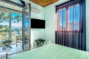 a bedroom with a bed and a large window at Old Boat double studio 11 in Nikiana