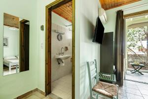 a bathroom with a sink and a toilet and a mirror at Old Boat double studio 8 in Nikiana