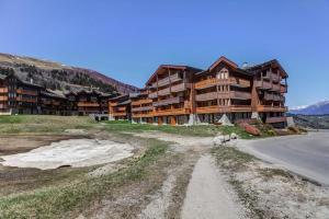 a large wooden lodge with a road in front of it at Quartier La Forêt - maeva Home - Appartement 2 pièces 5 personnes - Sélection MAE-5271 in Valmorel +26 photos