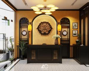 a lobby with clocks on the wall and a table at Omina Hanoi Hotel & Travel in Hanoi
