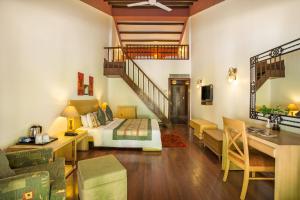 a living room with a bed and a staircase at The Riverview Retreat Corbett by Leisure Hotels in Garjia