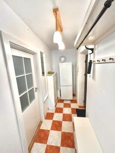 a hallway with a checkered floor and a refrigerator at Linden Copou in Iaşi