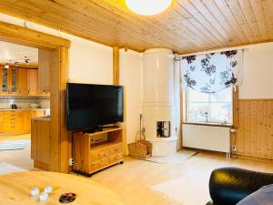 a living room with a flat screen tv on a wooden cabinet at Lillstugan Sälen by in Sälen