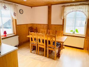 a dining room with a wooden table and chairs at Lillstugan Sälen by in Sälen