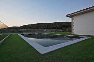 a swimming pool in the yard of a house at Casa Dávó in Leiria
