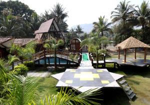 a resort with a pool and a house with a slide at Sahyadri Pride in Wai