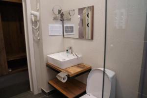 a bathroom with a sink and a toilet at BURSA in Taraz