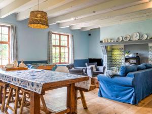een woonkamer met een tafel en blauwe muren bij Modern Holiday Home in Damme with Private Garden in Damme