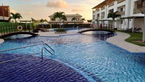 a large pool with blue water in a resort at Paraíso Canoa Quebrada in Canoa Quebrada