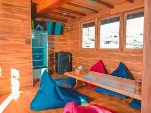 a wooden cabin with a wooden table and chairs at Trip Labuanbajo 3D2N departure every Friday in Labuan Bajo