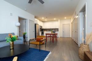 a living room with a table and a kitchen at Modern Nulu 2BR CozySuites Unit 03 in Louisville