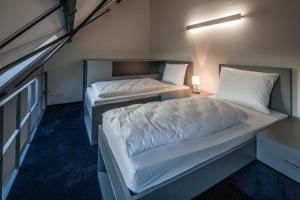 2 Betten in einem kleinen Zimmer mit in der Unterkunft Haus Overbach in Barmen