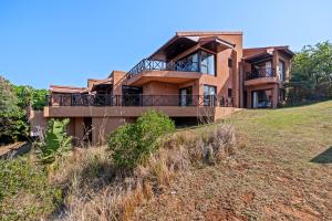 a house on the side of a hill at San Lameer Villa - 14328 - 4 Bedroom Deluxe - 8 pax - San Lameer Rental Agency in Southbroom