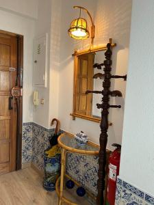 a room with a glass table and a lamp at 2 Bedroom apartment in Caparica by the beach in Costa da Caparica