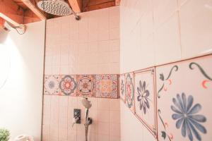 a bathroom with tiles on the wall with a shower at Macário Cosy Loft in Porto