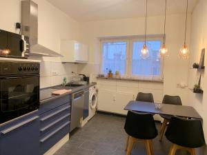 a kitchen with a table and chairs in it at Wohnung mitten in der Altstadt in Koblenz