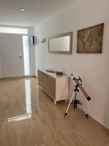 a room with a dresser and a camera on a tripod at Cullera Mountain View in Cullera