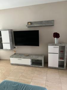 a living room with a flat screen tv on a wall at Cullera Mountain View in Cullera