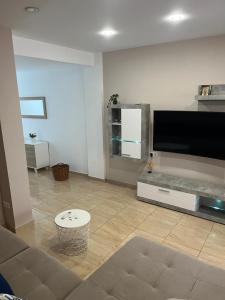 a living room with a large flat screen tv at Cullera Mountain View in Cullera