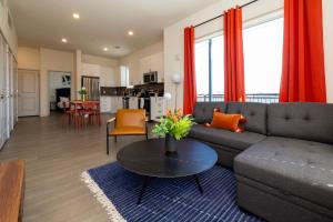a living room with a couch and a table at Modern Nulu 2BR CozySuites 04 in Louisville