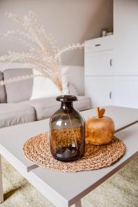 a glass vase sitting on a table with two pumpkins at KOCHWERK Restaurant & Pension in Zingst