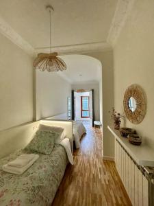 a bedroom with a bed and a mirror on the wall at Los Magnolios de Laín Calvo in Burgos