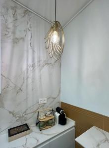 a bathroom with a white marble shower curtain and a light at Los Magnolios de Laín Calvo in Burgos