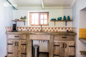 a kitchen counter with a sink and a window at Kas Hamaka in Kralendijk