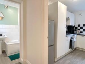 a kitchen with a sink and a refrigerator at HNFC Stays - Ideal for Business Travellers -2b in Gateshead