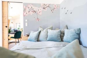 ein Schlafzimmer mit einem Bett mit blauen Kissen in der Unterkunft Exklusives Design-Apartment & Sauna in Warngau
