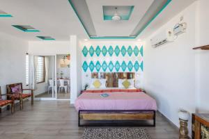 a bedroom with a bed and a living room at Surfside Haven By JadeCaps 1BHK By Udupi Beach in Kōtatattu
