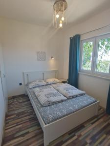 a bedroom with a bed in a room with a window at Holiday Home Drescher in Murter