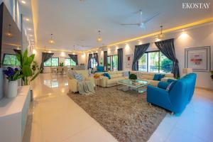 a large living room with blue couches and a rug at Ekostay Luxe - CASA SIA - Ideal for Weddings - Poker Table in Lonavala