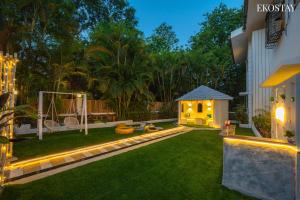 a backyard with a gazebo in the yard at night at Ekostay Luxe - CASA SIA - Ideal for Weddings - Poker Table in Lonavala
