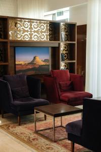 a living room with two chairs and a coffee table at Holiday Inn Aktau, an IHG Hotel in Aktau