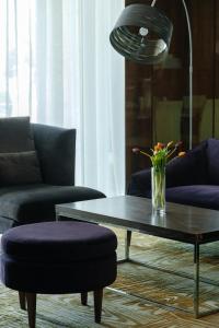 uma sala de estar com uma mesa de centro e um vaso de flores em Holiday Inn Aktau, an IHG Hotel em Aktau