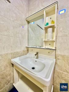 a bathroom with a sink and a mirror at Well Hotel By Maco at Legoland in Gelang Patah