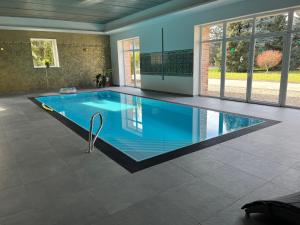 a large swimming pool in a house at Hotel Dvůr in Krnsko