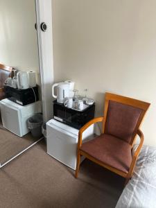 um quarto com uma cadeira e comodidades para preparar café em 30 College Street, Buckhaven, Leven, Fife, KY81JX em Buckhaven