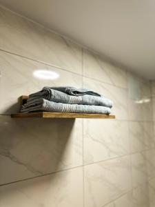a pile of towels sitting on a shelf in a bathroom at GRAND LOFT OTEL in Bursa