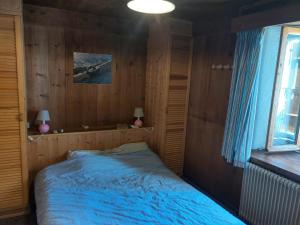a bedroom with a bed in a wooden room at Chalet La Gayolle - Chalets pour 12 Personnes 96 in Saint-Gervais-les-Bains