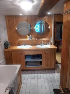a bathroom with two sinks and two mirrors at Chalet La Gayolle - Chalets pour 12 Personnes 96 in Saint-Gervais-les-Bains